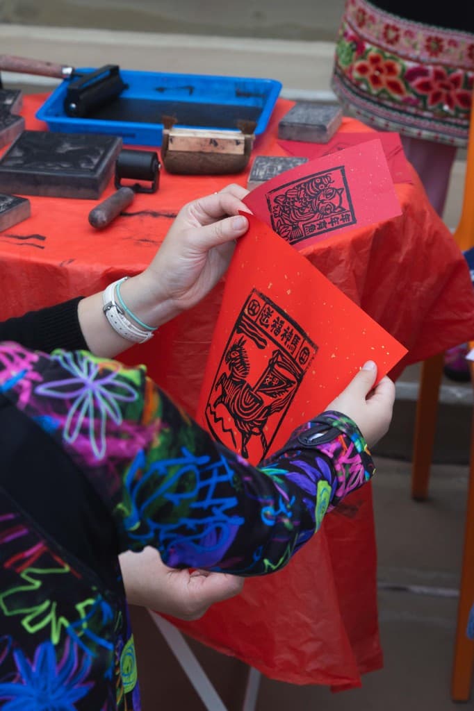 Woodblock printing workshop with red paper prints at Memory of China