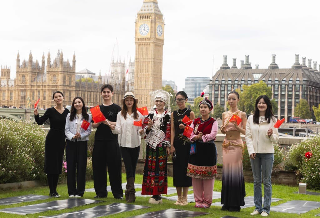 Festival performers and guests with Chinese flags on Members' Terrace, Big Ben behind
