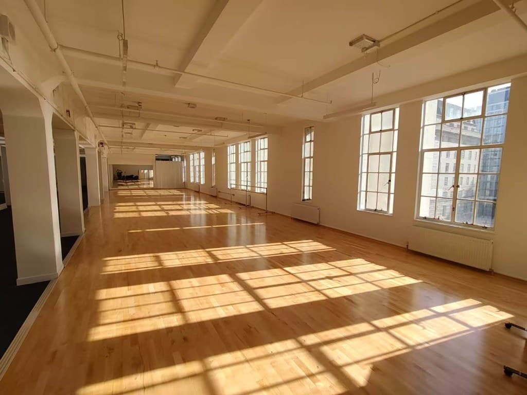 Sunlit wooden-floor venue with tall windows at County Hall