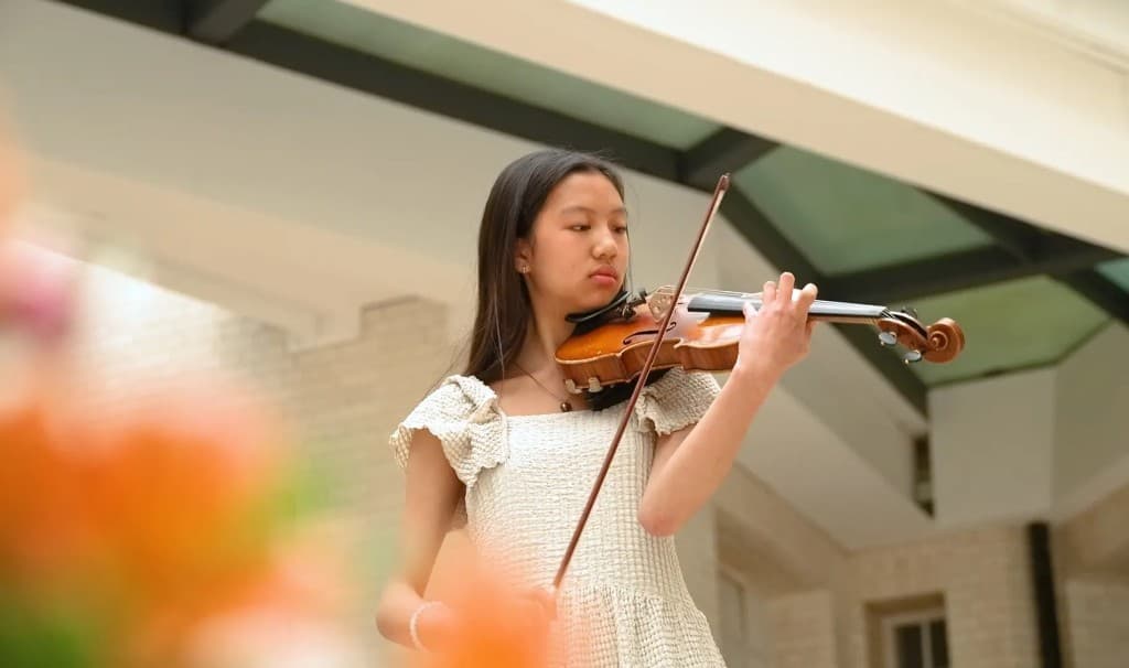 Young musician performing violin at the Four Seasons Festival